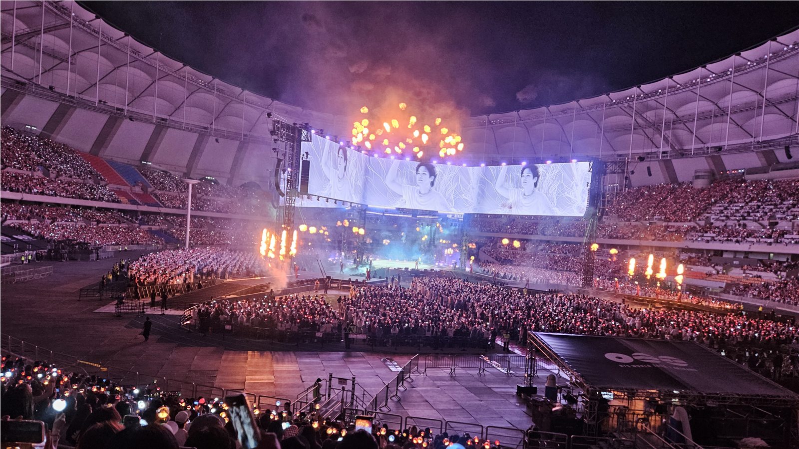 Wide view of the BTS ARIRANG concert and flame effects at Busan Asiad Main Stadium