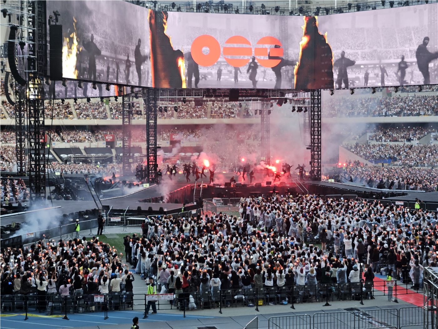 Wide concert-stage view with red lighting during BTS ARIRANG in Busan