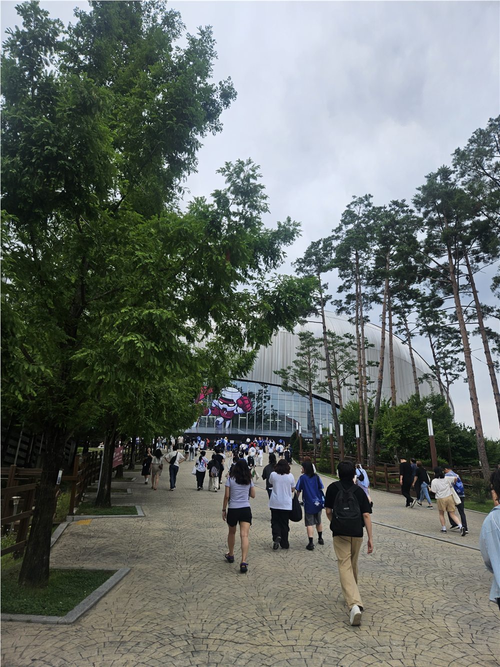 Spectators walking toward Gocheok Sky Dome before a baseball game