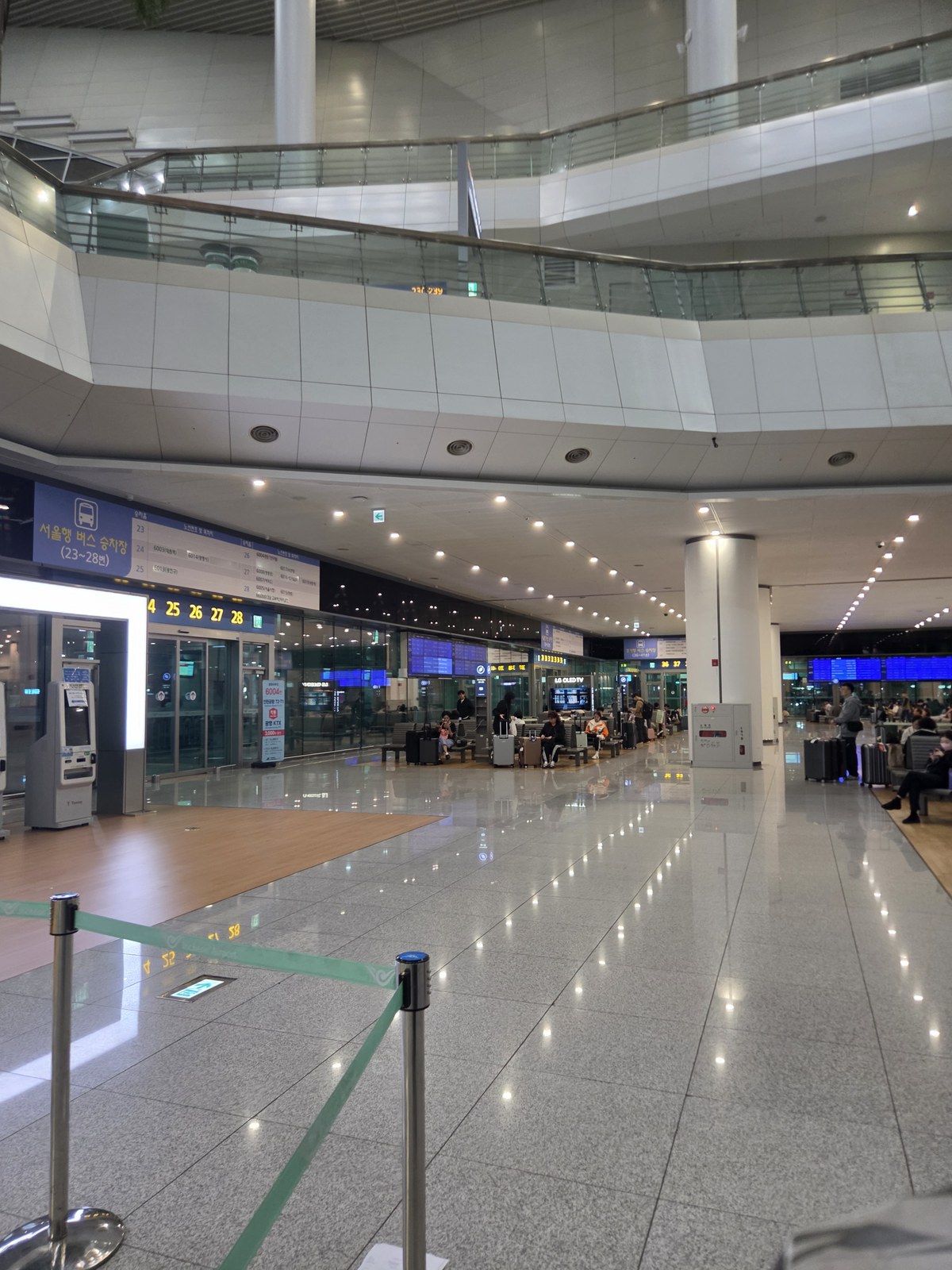 Indoor bus waiting hall and numbered boarding doors at Incheon Airport Terminal 2