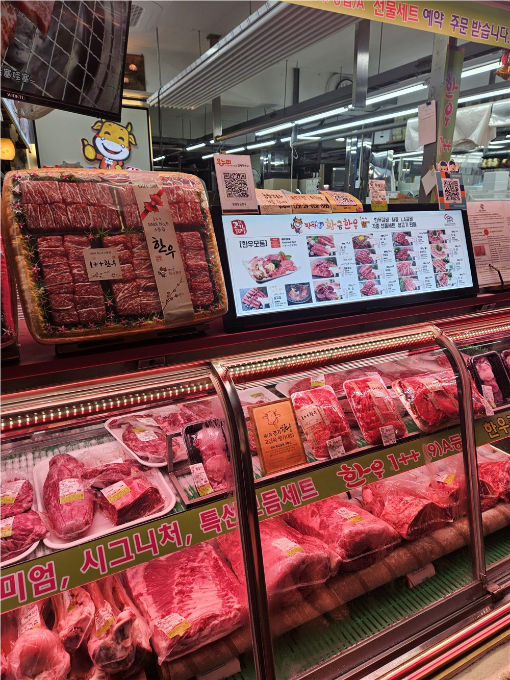 Hanwoo cuts and gift sets displayed at a butcher counter in Majang Meat Market